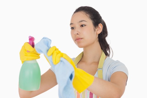 Deep cleaning kitchen surfaces and appliances during a move-out clean in Greenwich